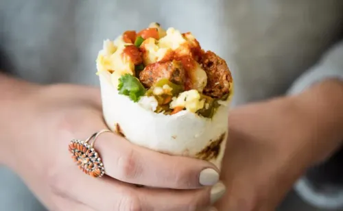 Woman holding a breakfast burrito